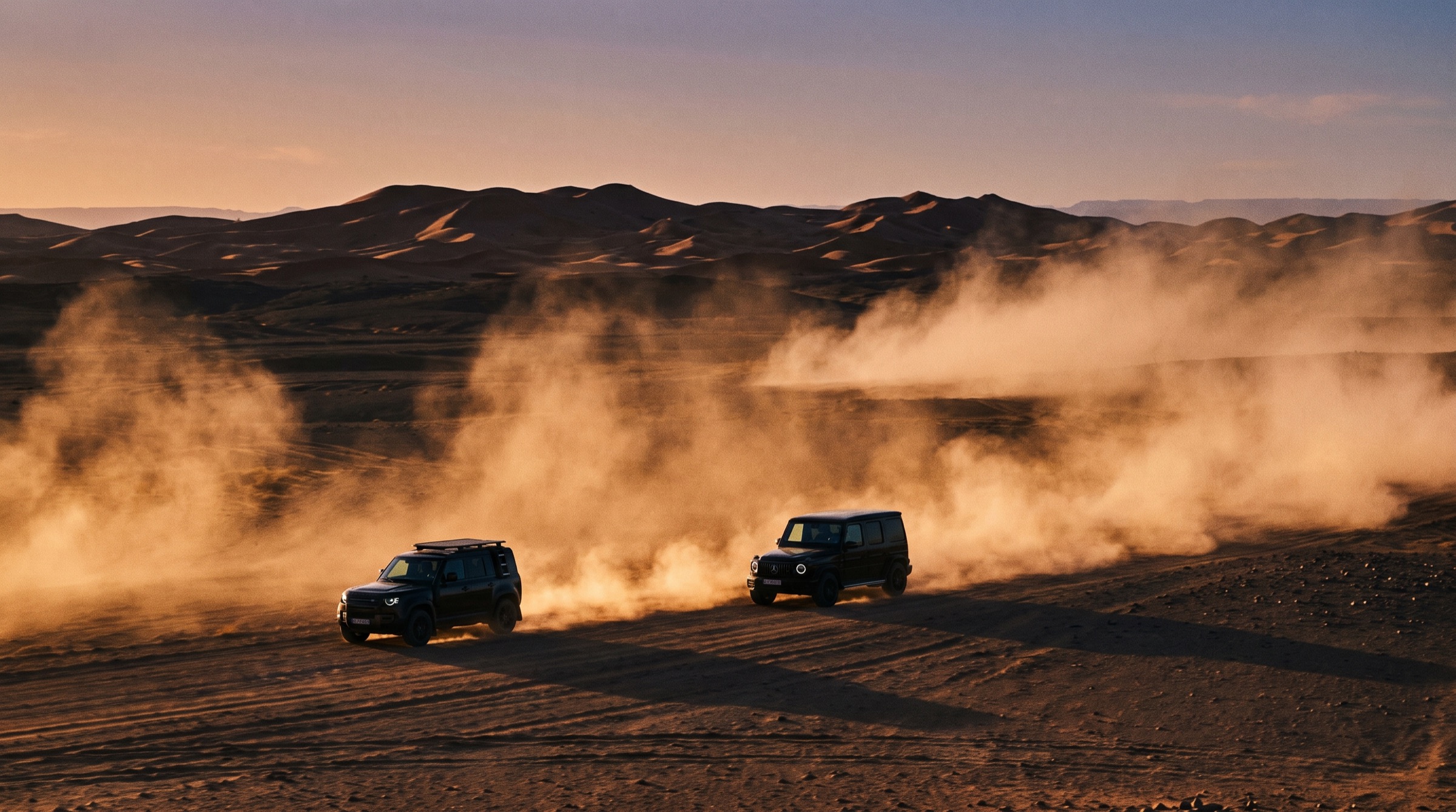 Two Land Cruisers crossing the desert in convoy